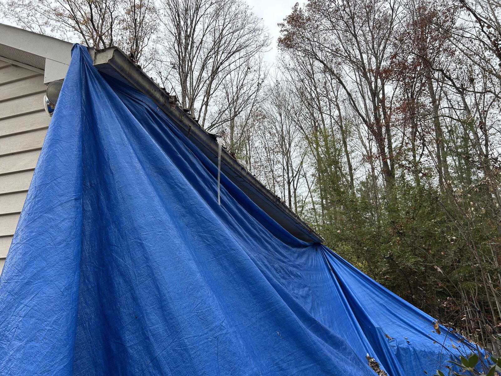 Advantage Roofing protecting property with tarps during roof replacement